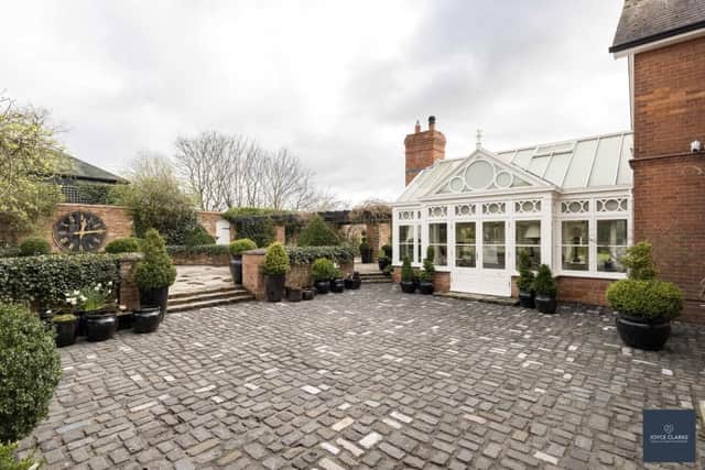 Fully enclosed gardens featuring cobbled courtyard and barn style entertaining room. (Pic: Joyce Clarke)