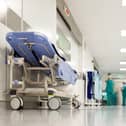 Blurred figures of people with medical uniforms in hospital corridor