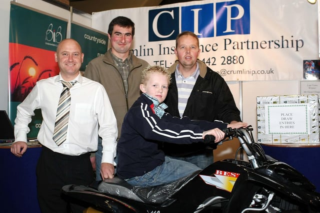 Anthony Murray, CIP Insurance, with Johnny Boyd, Kircubbin, and Andrew Martin and son Philip from Portavogie check out the prize on offer on the CIP stand at the RUAS Winter Fair.