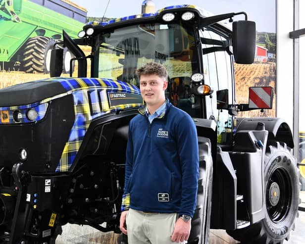 Angus Weir, son of Doddie Weir, welcomes the fundraising tartan JCB Fastrac tractor off the production line in Cheadle, Staffordshire. (Pic: John Taylor)