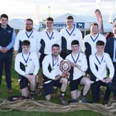 Tug of war novice winners, Trillick and District YFC with John Thompson and Sons representative, Nathan Harvey and YFCU president, Stuart Mills