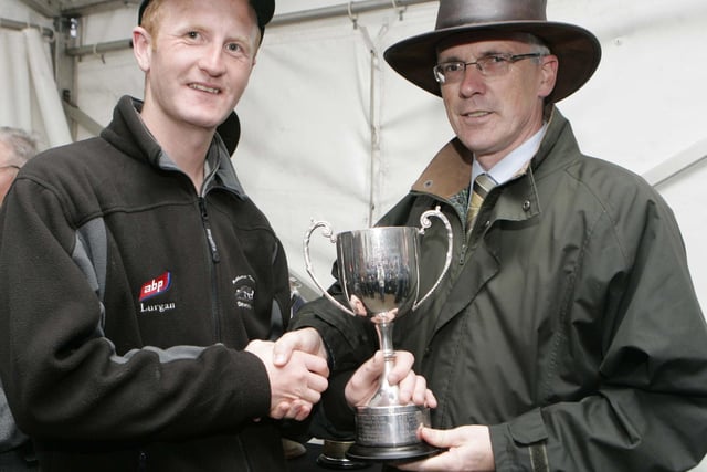 John Henning Northern Bank presents Michael Gallagher with his prize at the international sheep dog presentation of prizes at McQuillan's farm Masserene Antrim. Picture: Steven McAuley/Kevin McAuley Photography Multimedia