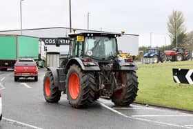 Tractors, trucks and other agricultural vehicles did laps of the Nutts Corner roundabout in Co Antrim, briefly disrupting traffic as police looked on on Tuesday afternoon. Picture by Stephen Davison