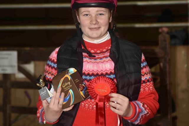 Flora Clark proudly displays her 55cm prize - Photo by Equi-Tog