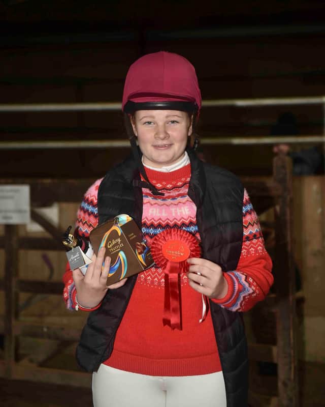 Flora Clark proudly displays her 55cm prize - Photo by Equi-Tog