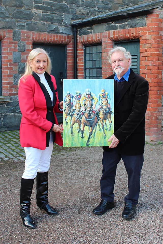 One of Ireland's top equestrian artists Leo Casement presents Joan Cunningham with a fabulous painting to be sold to raise money for the Kulama Uganda Project