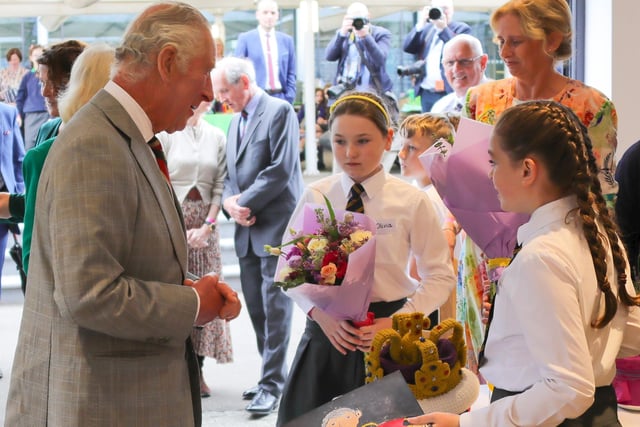 Olivia Leonard and Ava Connolly, year seven pupils at Jones Memorial Primary School, presented flowers to the King and Queen and Ava made a portrait of the King which she presented to him.