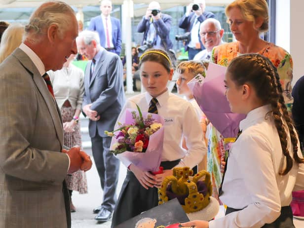 Olivia Leonard and Ava Connolly, year seven pupils at Jones Memorial Primary School, presented flowers to the King and Queen and Ava made a portrait of the King which she presented to him.