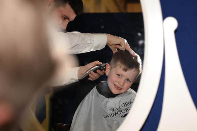 Archie McKendry getting his hair cut at Ballymena mart