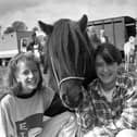 Pictured in September 1992 at the Ahoghill Horse Fair is Noreen Hamill, right, who was celebrating her 14th birthday at the fair with Pauline McKeown from Randalstown, and Charlie the pony. The premier championship award at the fair was awarded to Robert Campbell of Ballymena for his Clydesdale mare with foal. Picture: News Letter archives/Darryl Armitage