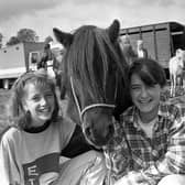 Pictured in September 1992 at the Ahoghill Horse Fair is Noreen Hamill, right, who was celebrating her 14th birthday at the fair with Pauline McKeown from Randalstown, and Charlie the pony. The premier championship award at the fair was awarded to Robert Campbell of Ballymena for his Clydesdale mare with foal. Picture: News Letter archives/Darryl Armitage