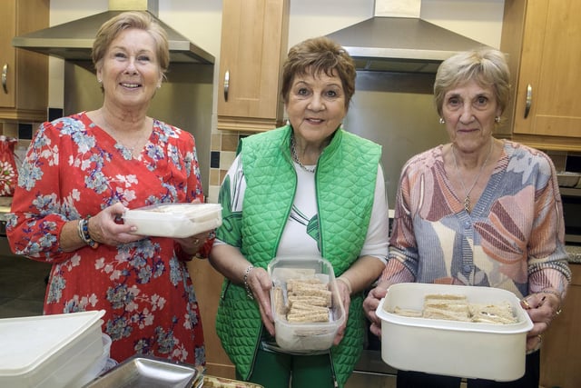 Helping out in the kitchen at the Fashion Show are, Anne, Barbara and Jennifer.