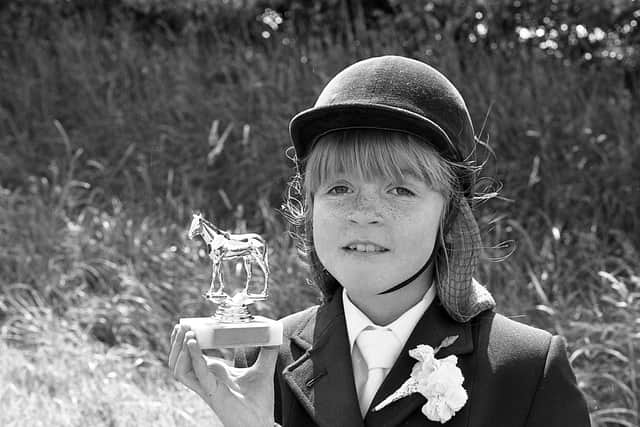 Pictured in late July 1980 is eight-year-old Joanne Bailey from Newtownards, who is seen showing of the handsome trophy which she won with her pony on the leading rein class at the Greyabbey Show. Picture: News Letter archives/Darryl Armitage