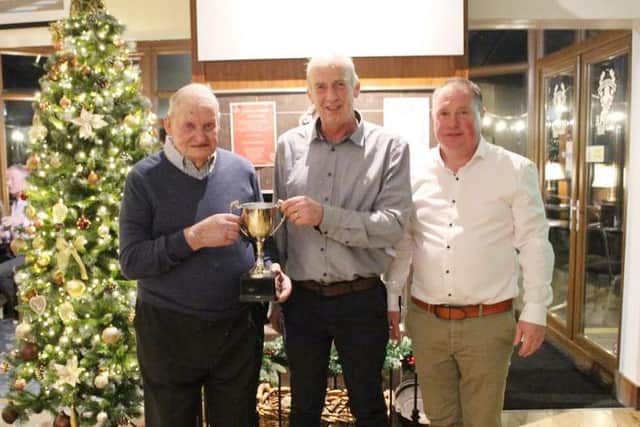Ivan Gordon, centre, accepted the Young Show Herd of the Year Cup won by the Ervine family with their Knockagh British Blue Cattle Herd. For the best of reasons the family were unable to attend due to the birth of a baby boy to Laura. Johnny Young, centre, Club President and event sponsor made the presentation assisted by Club chair Oliver McCann from Castlewellan.