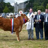 Brian McElroy from Dromara, Co Down,  pictured with the junior overall heifer champion along with judges Trevor Masterson and John Gordon at the Castlewellan Show in July 2002. Picture: News Letter archives/Gavan Caldwell