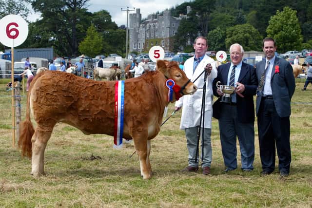 Brian McElroy from Dromara, Co Down,  pictured with the junior overall heifer champion along with judges Trevor Masterson and John Gordon at the Castlewellan Show in July 2002. Picture: News Letter archives/Gavan Caldwell