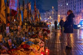 People light candles at the Independence Square to mark the fourth anniversary of the Russian invasion of Ukraine, in Kyiv, Ukraine, Tuesday, February. 24, 2026. (AP Photo/Dan Bashakov)