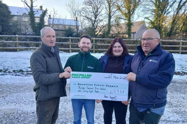 Brian Kerlin, Alan Patterson and Emma Kerrigan handing over a cheque to Aaron from MacMillan
