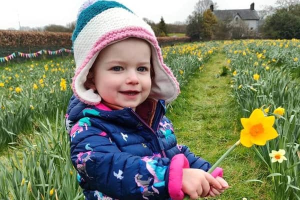 Charlotte McKeown with some daffodils from the field of hope