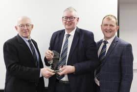 John Martin, Kesh, receives his Long Service Award from Michael Smale, left, chaiman, Holstein UK; and vice-chairman Wallace Gregg. 