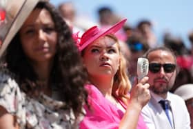 A racegoer uses an electric fan in the hot weather on day four of Royal Ascot at Ascot Racecourse, Berkshire.