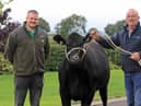 Stuart Hawthorne from Kinallen was the winner of the pedigree Aberdeen Angus heifer Coltrim Evana X747. He received his prize from Ivan Forsythe, Moneymore. Picture: Julie Hazelton