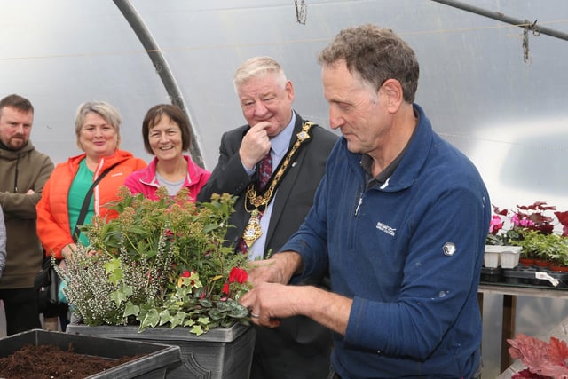 Andrew McClarty shows off a finished planter to, Move More Participants, family members and Mayor of Causeway Coast and Glens, Councillor Steven Callaghan. Pic: McAuley Multimedia
