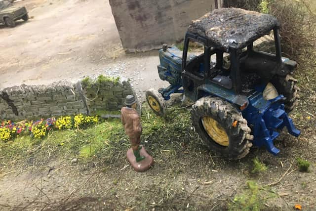A bad day out for this farmer as he surveys his fire damaged tractor.