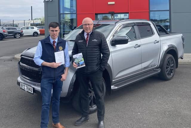 Ryan Lavery, chair of NI Dexter Cattle Group, discussing the premier show and sale catalogue with Peter Eakin of Eakin Brother Ltd