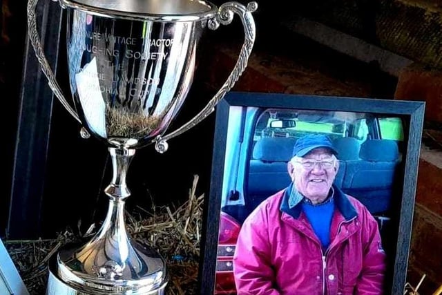 The new Memorial Trophy beside a photo of the late Frankie Davidson. (Pic: Ballynure Vintage Tractor Ploughing Society)