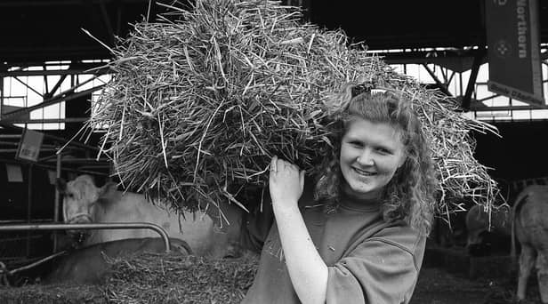 Carrying in the straw at Balmoral Show in May 1991 was no problem for Gillian Gibson from Ballygowan, the secretary of the new junior Blonde d'Aquitaine Club. Picture: Eddie Harvey/News Letter/Farming Life archives