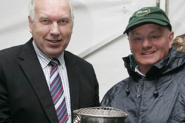 Roy Kennedy from Grow presents Ian Brownlee with his prize at the international sheep dog presentation of prizes at McQuillan's farm Masserene, Antrim. Picture: Steven McAuley/Kevin McAuley Photography Multimedia