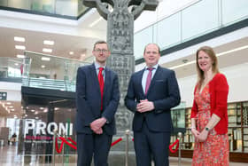 Communities Minister Gordon Lyons with Acting Director of PRONI David Huddleston and HERoNI’s Rhonda Robinson stand at the reconstructed Donaghmore high cross currently being exhibited at PRONI