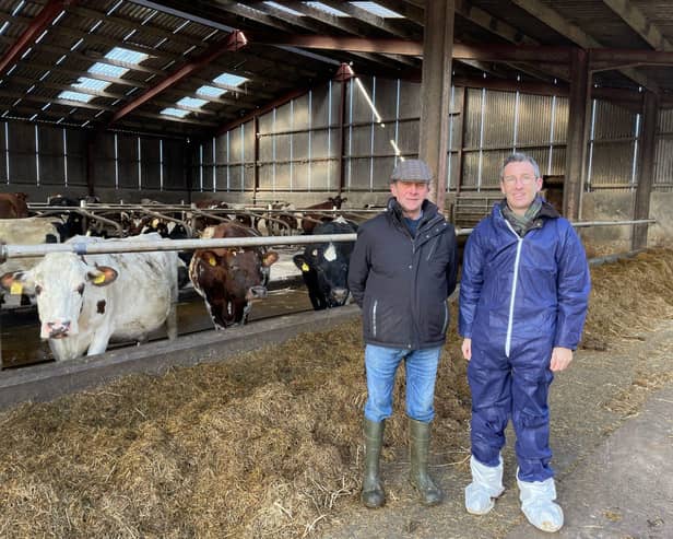 DAERA Minister Andrew Muir is pictured with dairy farmer James Brown. Pic: DAERA