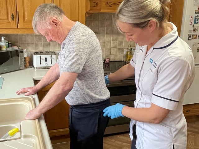 Physiotherapist, Laura Steenson going through exercises with Hugh