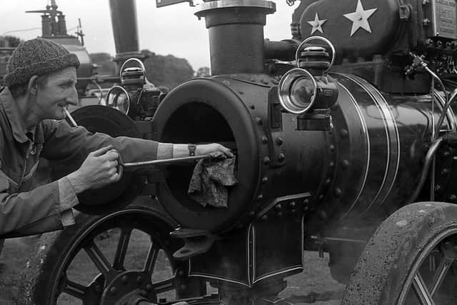 Pictured in late July 1980 is James Harkin from Ballymena who is seen cleaning out the boiler of a 1930 Marshall steam tractor at the Ulster Steam Traction Rally at Shane’s Castle. The grand old steam engines of long ago proudly showed their paces, some after a long journey from England. Picture: News Letter archives/Darryl Armitage