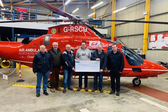 Members of the ‘Craigs Tractor Enthusiasts’ Club hand over a generous donation of £6,000 to Air Ambulance Northern Ireland.