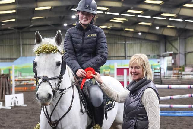 Kym Moore receiving 1st place Rosettes from Gillian Creighton (1st & 2nd 1.10m). (Pic: Lyndon McKee Photography)