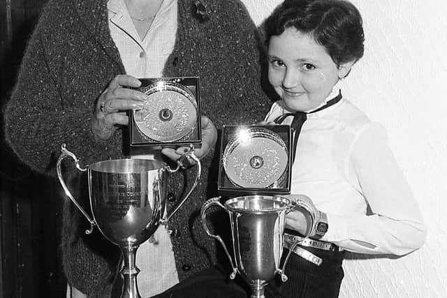 Pictured in October 1982 at the Mounthill Fair Society dinner and prize distribution at Kilwaughter is Mrs Elsie Carlisle, Ahoghill, and her grand-daughter with two of the top trophies for the best foal at Mounthill Fair. Picture: Farming Life/News Letter archives