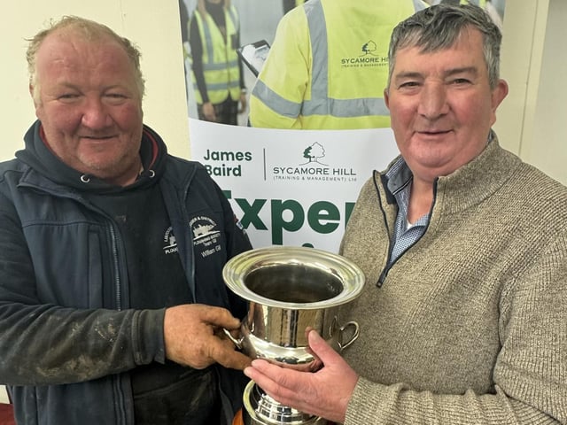 Willam Gill receives his trophy from host Mr James Baird for winning the Vintage Senior Class at Listooder Ploughing match. William was Reserve Vintage Champion