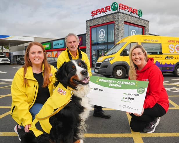 Caitlin McCartney, Ken Humphrey and Harvey the dog from SOS Bus NI are pictured with Bronagh Luke from SPAR NI, receiving their Community Cashback Grant last year. Applications for the 2024 Grant are open until 22nd May, and this year will see 20 organisations receive £1,000 each.