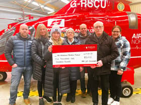 Pictured is Lee Gilliland’s family (left to right), Colin, Shirley, Zoe, Eileen, Graeme, William & Lynne presenting a cheque for £5,100 at the Air Ambulance NI base in Lisburn.