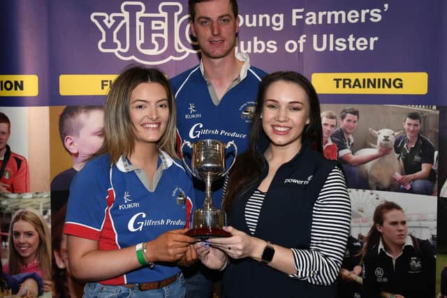 Collone YFC members, Karen Walker, and Harry Chambers, collecting the Ann Cameron Cup for club of the year from Power NI’s marketing manager, Amy Bennington