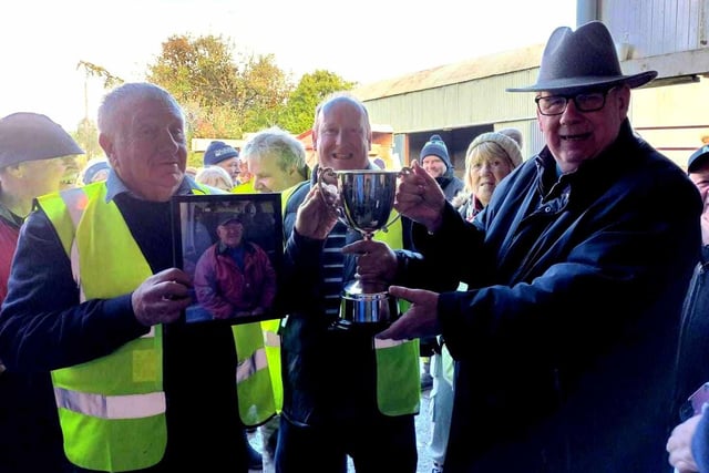 Allen McAnally (centre), Chairman of Ballynure Vintage Tractor Ploughing Society, receives the new cup from Martin Mehaffey and Brendan Degnan. (Pic: Ballynure Vintage Tractor Ploughing Society)