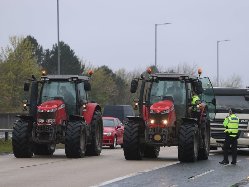 A police officer speaks to a driver on Sydenham by-pass in Belfast, as the National Fuel Protest against rising fuel prices continues. Picture date: Tuesday April 14, 2026. PA Photo. Photo credit should read: Liam McBurney/PA Wire