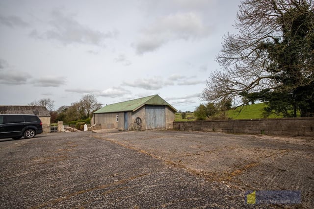 Two concrete yards and an array of useful outbuildings are included.