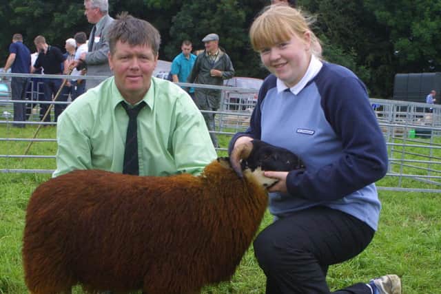 Robert Loughery and Sarah Jayne Loughery with the Blackface champion at the Antrim Show in July 2002. Picture: News Letter archives/Kevin McAuley