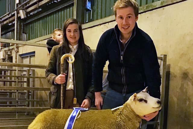 Jonny Bell accepts the Fane Valley Reserve Champion rosette from Judge Naomi O'Hare handing over the Fane Valley Champion rosette at the NI Texel Sheep Breeder's Show and Sale in Hilltown for his Kiltariff ram lamb exhibit.