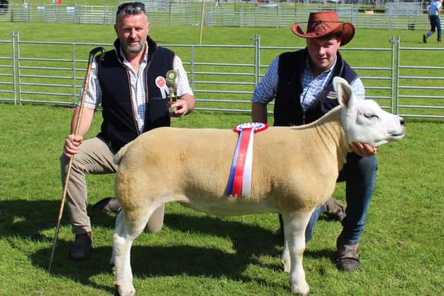 Martin McConville with the inter breed sheep champion at Lurgan Show 2023. Adding his congratulations is Alistair Christie, who judged the class.