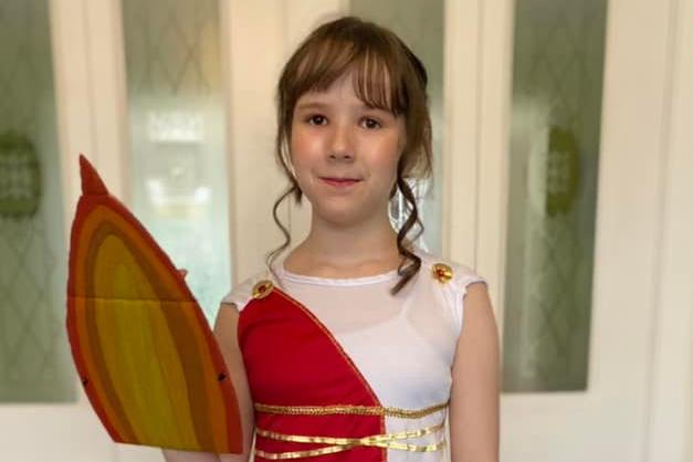 Ophelia Burrett, age 10, is dressed up as a Greek goddess, inspired by Maz Evans' book series, Who let the Gods Out?